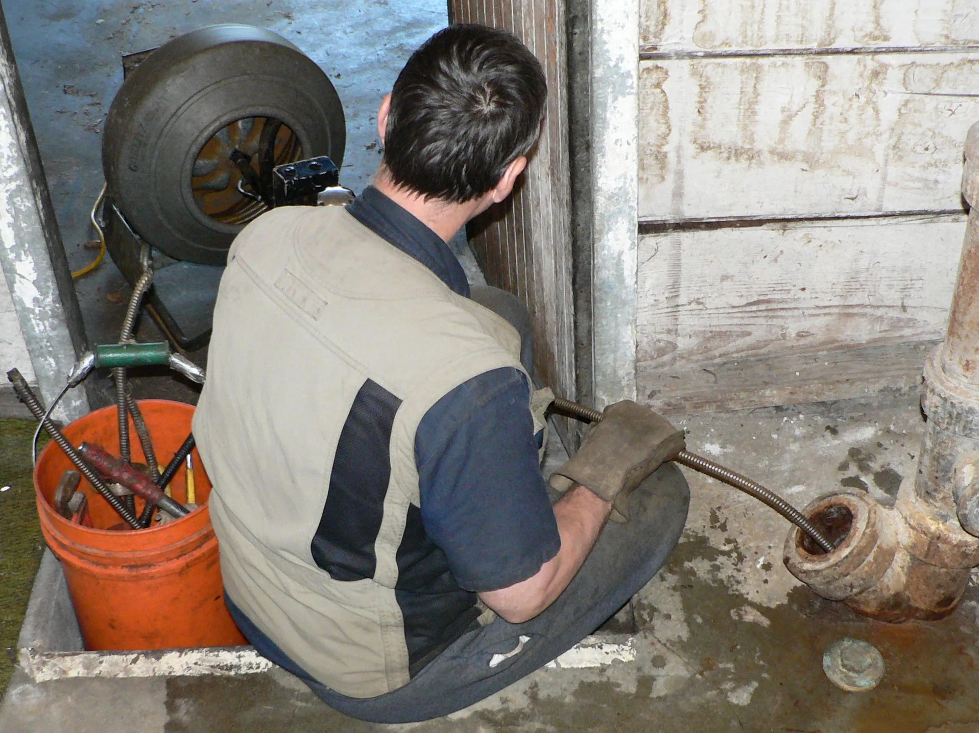 Motorized heavy-duty plumber's snake; cleaning a residential side sewer line in Seattle, Washington. Drain Cleaning Prices Canada: What to Charge After GST and HST